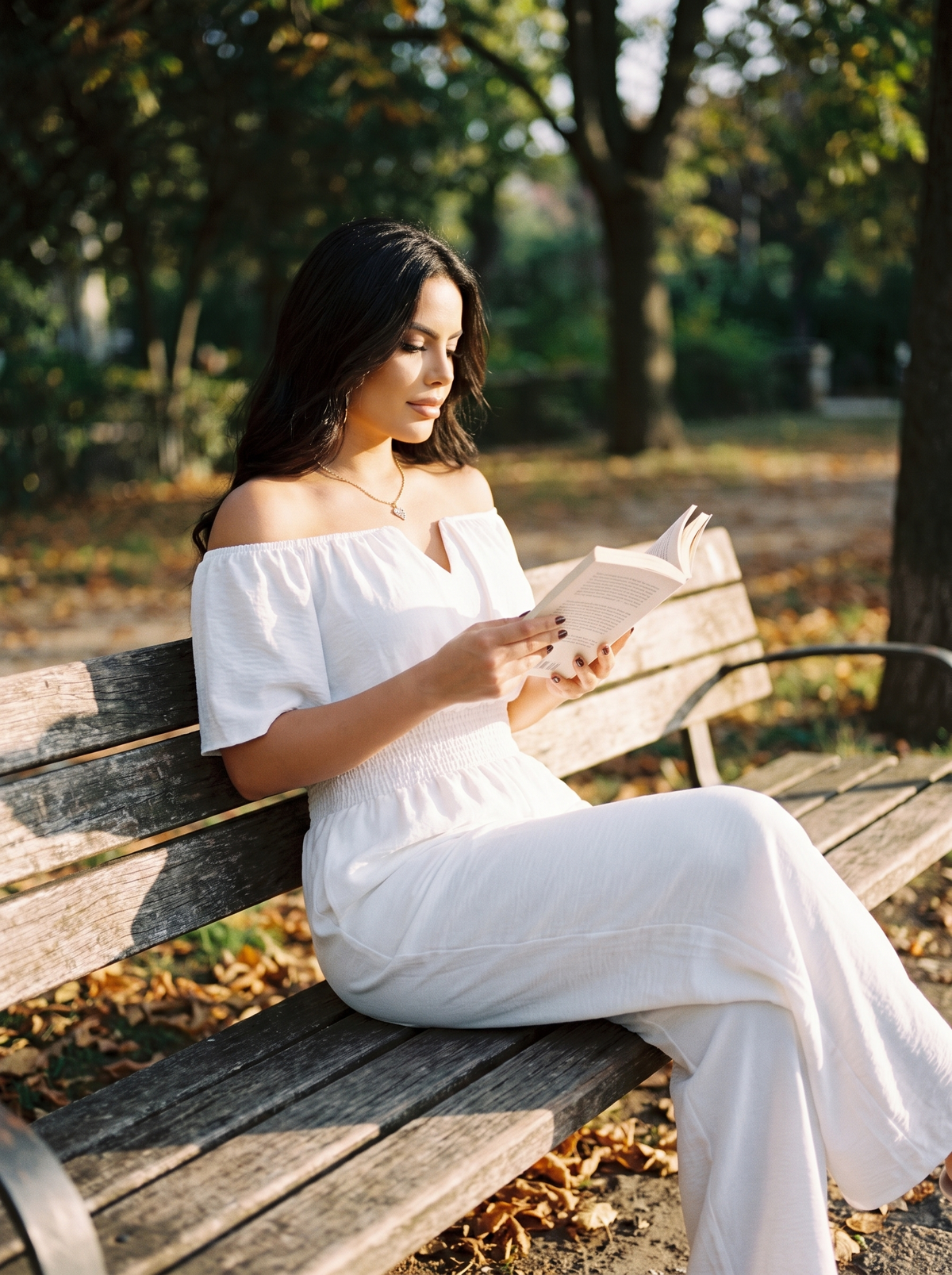 Off Shoulder Shirred Waist Jumpsuit on a park bench